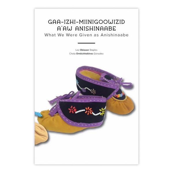 Book cover of Gaa-Izhi-Miinigoowizid-A'aw Anishinaabe with image of two baby booties on white background.