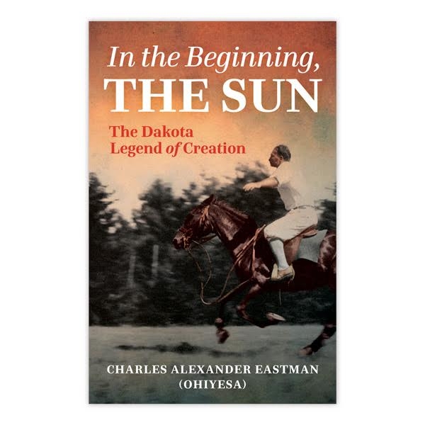 Book cover of "In the Beginning the Sun" with color photo of man riding a galloping horse in grassy field. Trees in background. 