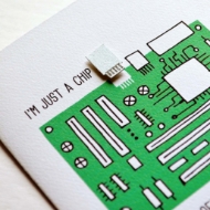 Closeup detail of white greeting card with green illustration of computer motherboard. Text reads, "I'm just a chip off the old motherboard."
