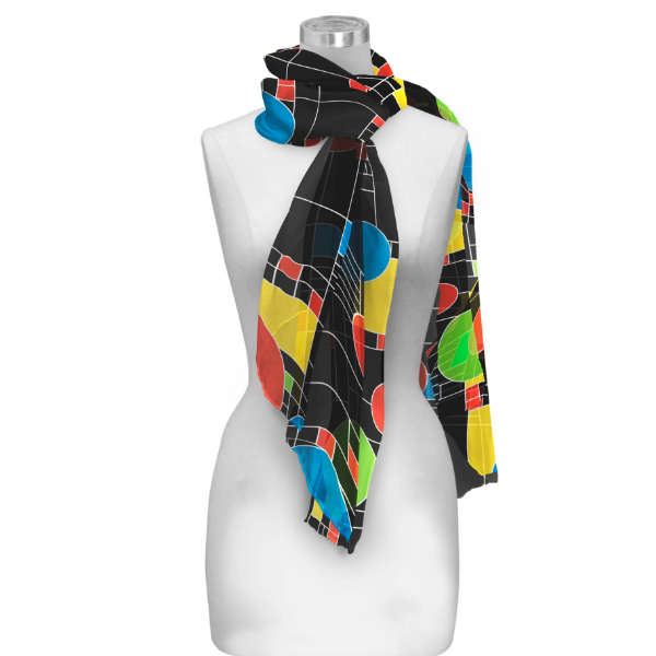 Colorful scarf tied around white mannequin form. The scarf has colorful, geometric "Coonley Playhouse" design by Frank Lloyd Wright. 