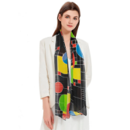 Brunette model wearing colorful sheer scarf. The scarf has colorful, geometric "Coonley Playhouse" design by Frank Lloyd Wright. 