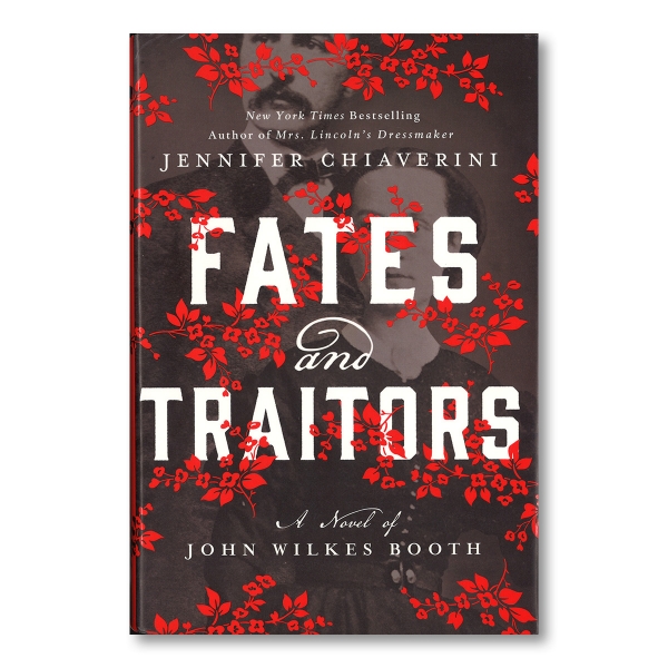 "FATES and TRAITORS" is written in large bold white letters, surrounded by red floral patterns. In the background is a black and white image of two people. Above the title, the author's name "JENNIFER CHIAVERINI," is written in white text. Below the title, in white script, "A novel of JOHN WILKES BOOTH," is written.