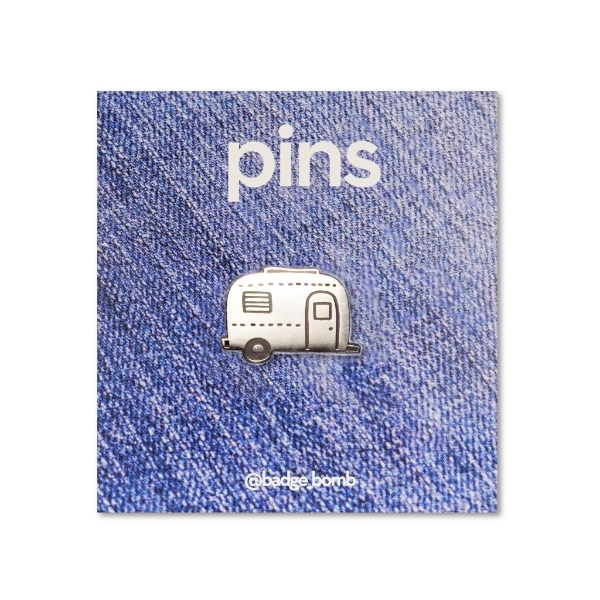 A pin of a silver camper 