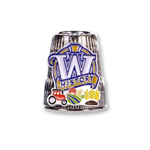 Front view of the thimble with the Wisconsin Historical Society logo. Below the logo is a picture of a red tractor, field and wheat 