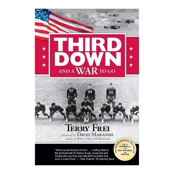 Book cover of "Third Down and a War to Go" Paperback Edition with black and white image of football team and title above in bold white font.