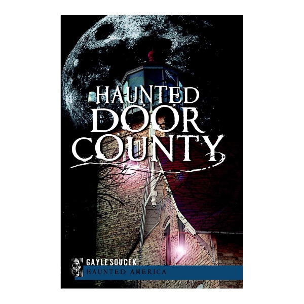 Front cover of "Haunted Door County" with an illustration of a moon and building in the background