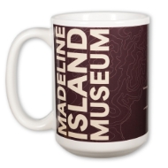 Large white mug with the words "Madeline Island Museum" in white font over dark brown background. 