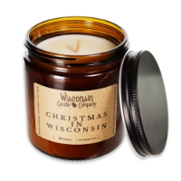 The Christmas in Wisconsin 16 oz candle in brown glass container with black metal screw-on lid removed to reveal wax and wick.