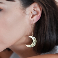 The Ruchi Crescent Moon Dangle Earrings - Gold  on a woman's ears