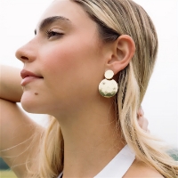 The Sitara Starry Double Circle Dangle Earrings - Gold on a woman's ears 