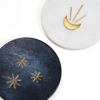 A closeup of two of the Indukala Moon Phase Marble Coasters