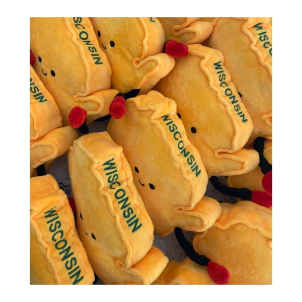 Yellow Wisconsin plush decor with green embroidery that says "Wisconsin."