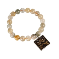 Natural stone bead bracelet with light, multicolored stone beads and a square charm attached.