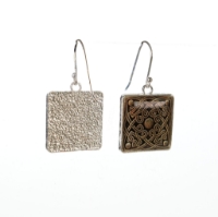 Two square dangle earrings with Celtic knot design. One turned to show textured back side.