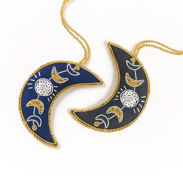 Crescent moon shape ornament with embroidered and beaded details.