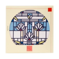 Round trivet with blue and white "Waterlilies" design by Frank Lloyd Wright. Pictured in its packaging.