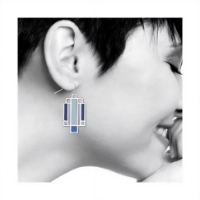 The Frank Lloyd Wright Willits "Light Screen" Earrings | Blue/Silver on the ear of a woman