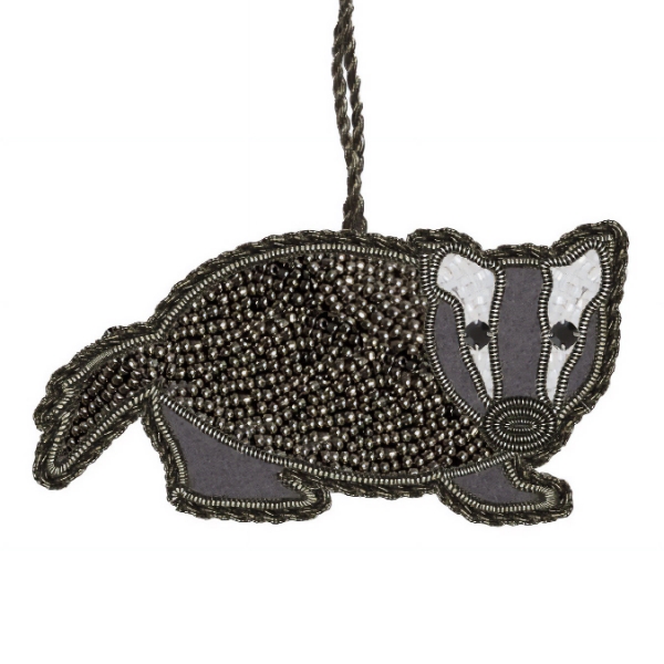 Dark gray ornament made with small beads representing a badger.