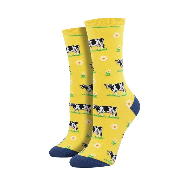 Yellow "Legendairy" socks with cows and daisies on a plain white background