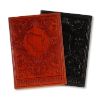 Two journals with leather covers embossed with the shape of Wisconsin surrounded by birds and leaves. One brown, one black.